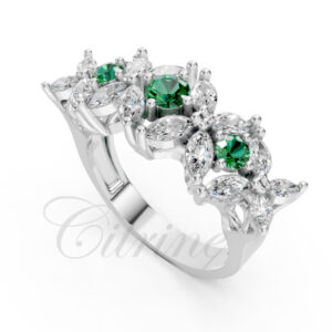 White gold ring featuring marquise diamonds and vivid green emerald accents, finished with Shellac and Altex
