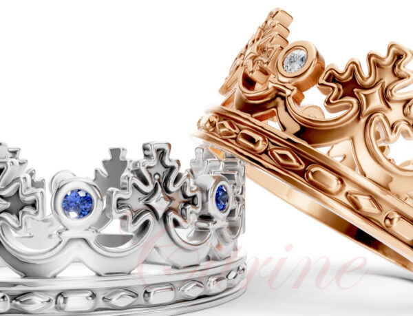Close-up of crown rings in rose gold and white gold with diamond and sapphire gemstones