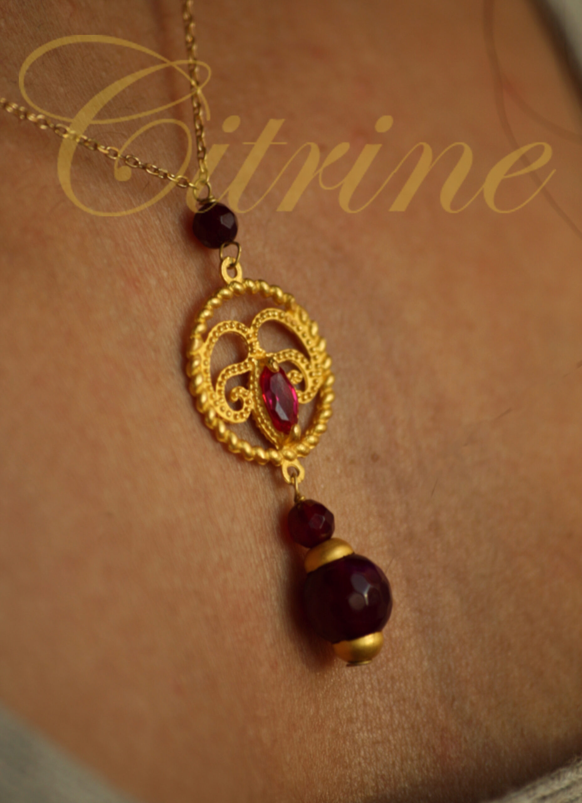 handmade gold filigree pendant with garnet beads