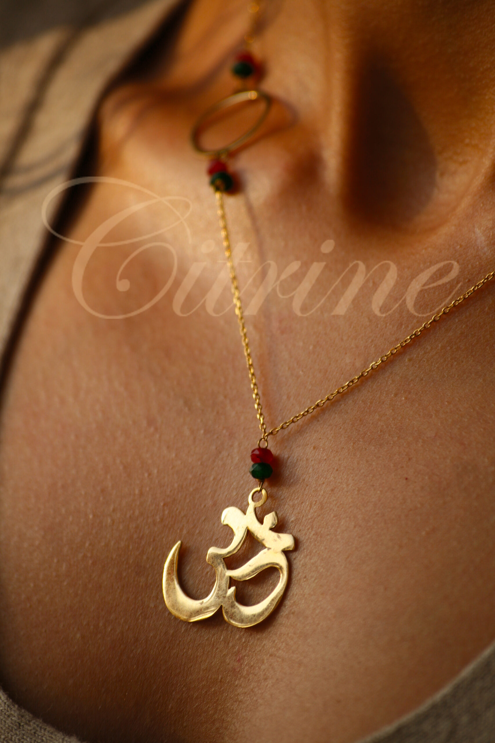 handmade gold pendant with red and green beads