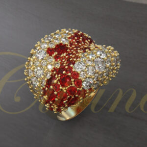 Gold dome ring pavé-set with red and white gemstones.