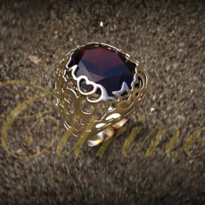 Gold filigree ring with a large red gemstone.