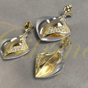 Two-tone leaf-inspired jewelry set in silver and gold with pavé-set stones.